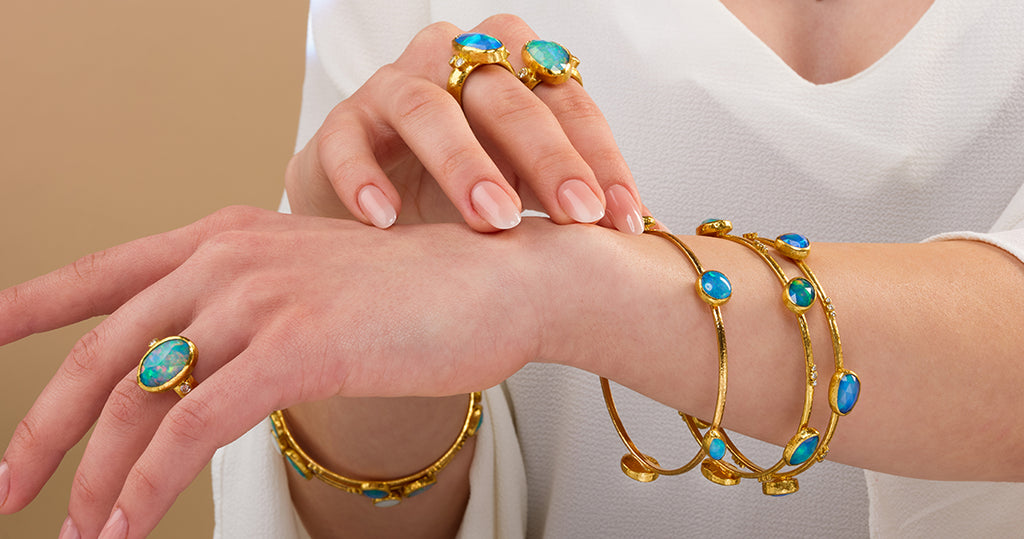 Sterling silver link bracelet and gold all around bracelet with black stone